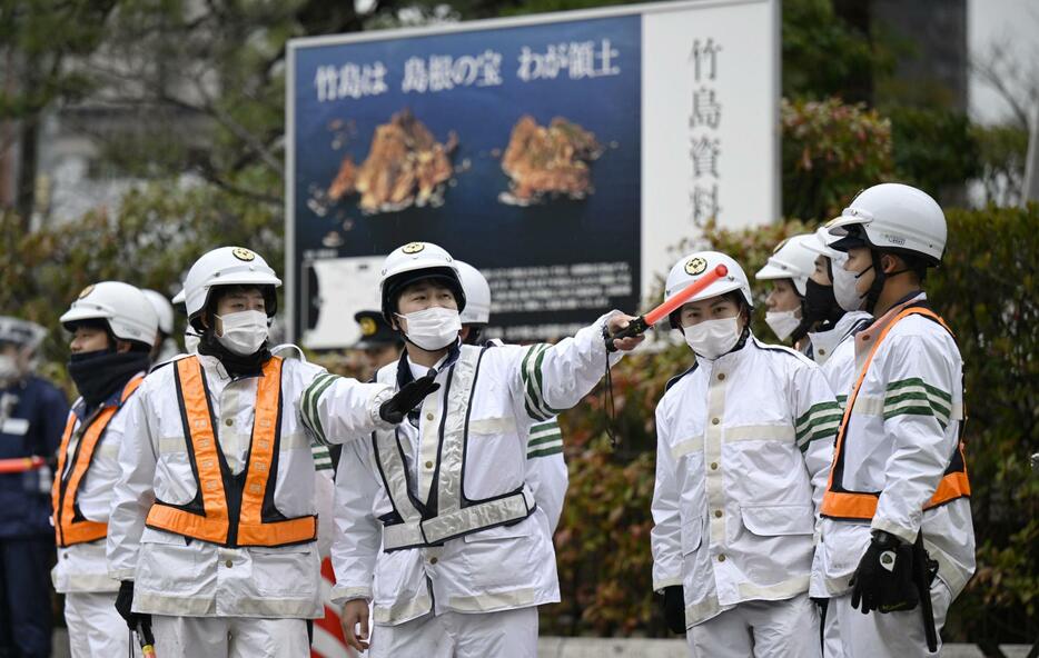 「竹島の日」式典会場周辺で警戒する警察官＝22日午前、松江市