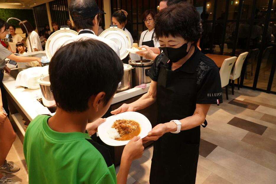 カレーを受け取る子ども＝シェフズトライテーブルで