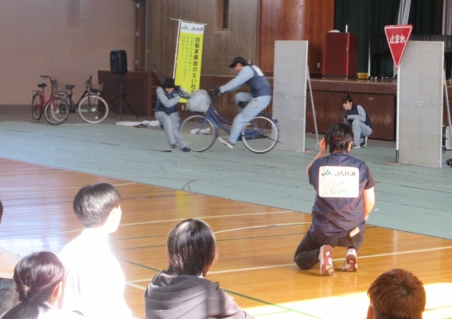 スタントマンによる事故の再現を見る生徒ら=23日、奈良市六条西の奈良県立大学付属高校