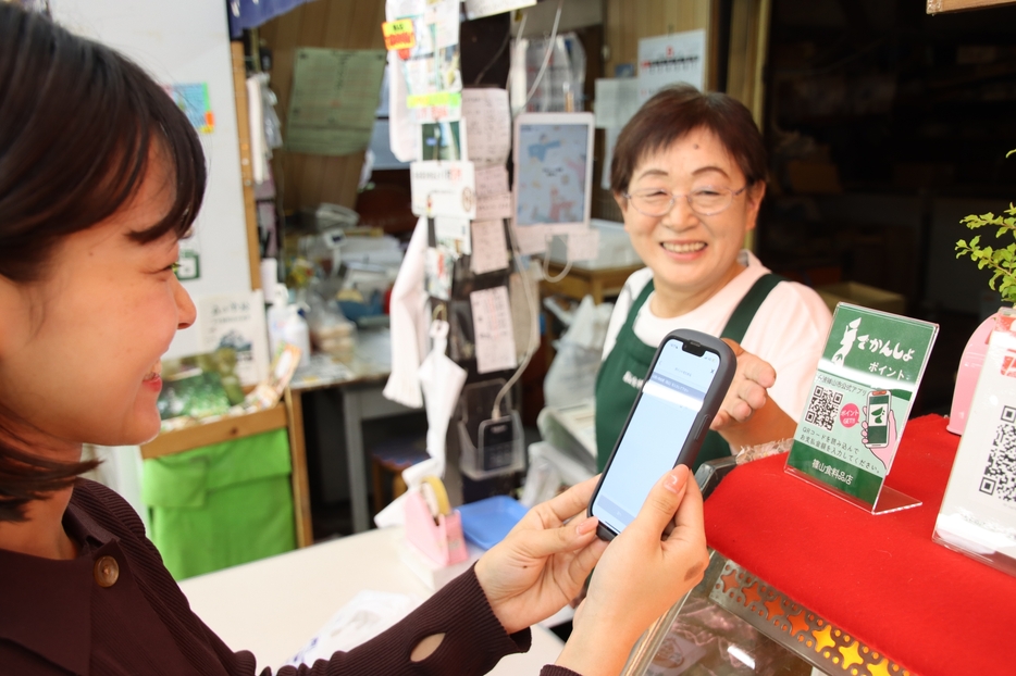 でかんしょポイントの利用を体験する観光大使ら＝兵庫県丹波篠山市二階町で