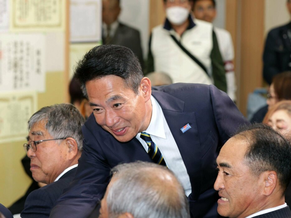 当選を確実にし、支持者と握手する前原さん（27日午後８時27分、京都市東山区）