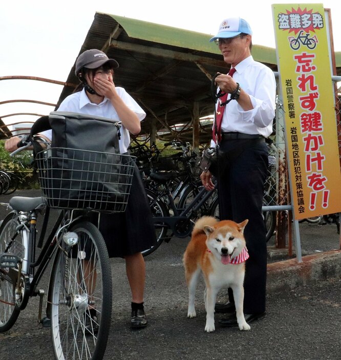 自転車の利用者㊧に盗難防止を呼びかける林さんと小太郎