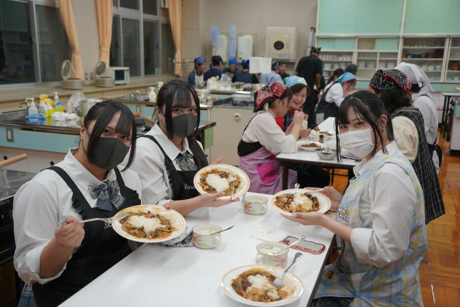 完成したビーフストロガノフを持つ生徒