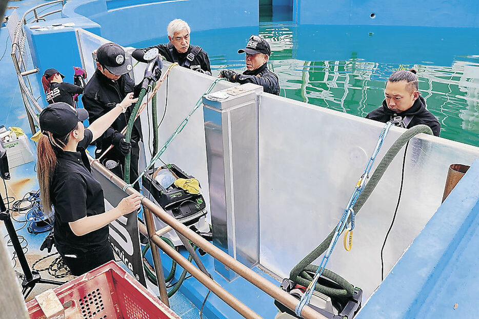 水槽を磨く関係者＝七尾市ののとじま臨海公園水族館