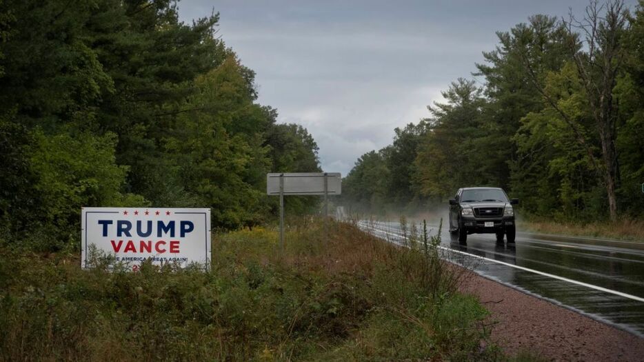 道路沿いに立つ共和党候補のトランプ氏への支持を示す看板＝９月６日、米ウィスコンシン州レミントン近郊