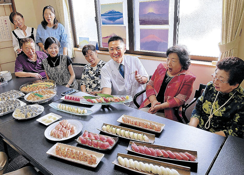 握りすしなどを提供する中村さん（右から３人目）＝砺波市中野