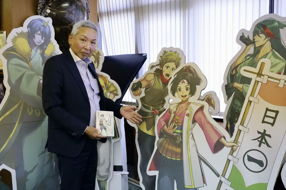 木曽川桃太郎外伝のキャラクターのパネルを紹介する犬山商工会議所の高橋秀治会頭＝2024年9月、愛知県犬山市