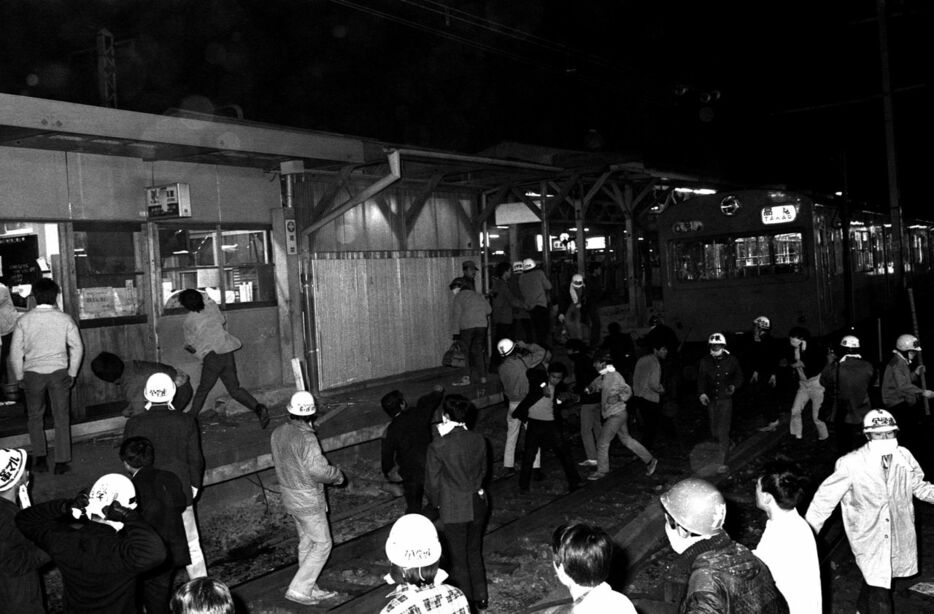 1968年10月21日夜、新宿駅構内になだれこみ、停車中の電車や駅事務室に投石して窓ガラスなどを破壊する学生ら（時事）