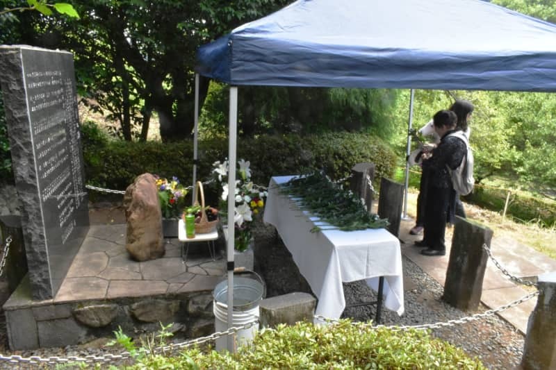 犠牲者の名前が刻まれた慰霊の碑と献花台