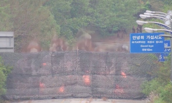 15日、北朝鮮が南北連結道路の京義線・東海線を爆破した瞬間、防護幕の後ろに煙と炎が上がっているのが見える＝国防部提供