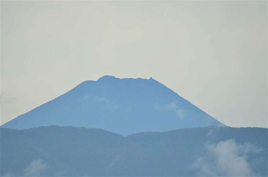 御坂山地越しの富士山、いまだに冠雪を確認できない＝26日、甲府市（平尾孝撮影）