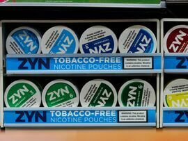 Zyn smokeless nicotine pouch containers for sale at a convenience store in New York.