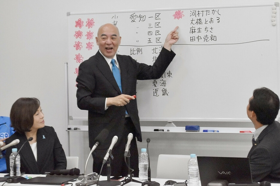 河村たかし氏が当選確実となり、笑顔を見せる日本保守党の百田尚樹代表（中央）＝２７日午後、東京都中央区