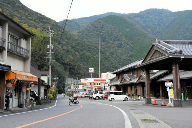 山あいにある村の中央商店街と「村所駅」と呼ばれるバス停。移動は車やバスが中心で、行き交う人の姿は少ない=2024年9月27日午後4時58分、宮崎県西米良村、福井万穂撮影