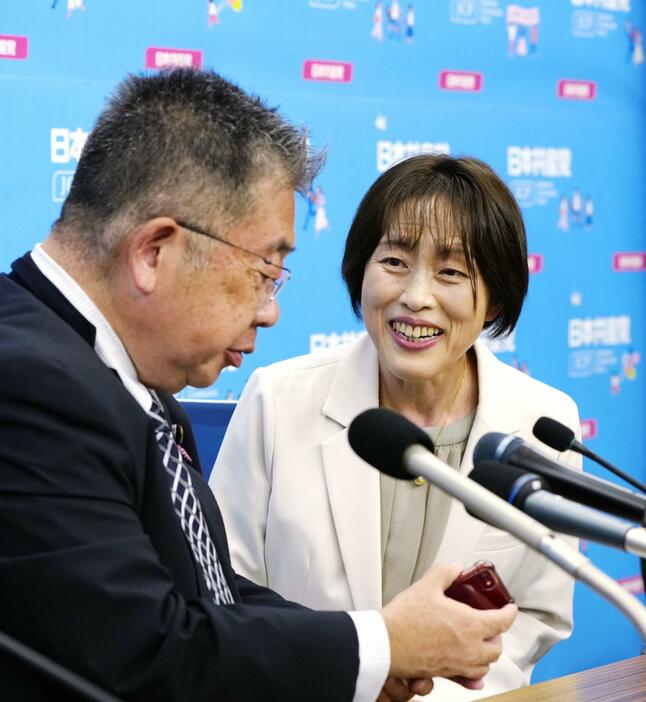 話をする共産党の田村委員長（右）と小池書記局長＝27日午後11時29分、東京都渋谷区の党本部