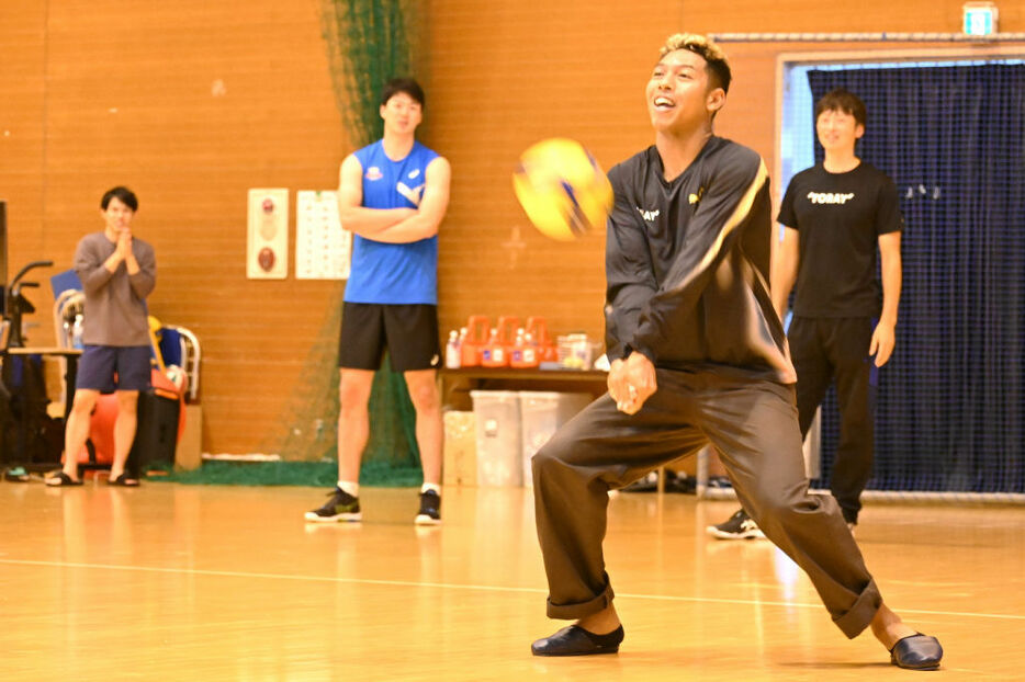 サーブレシーブに挑戦するサニブラウン・ハキーム選手＝9日午前、三島市の東レ体育館