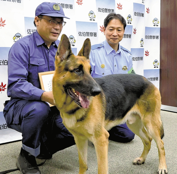 八田警部補（左奥）とともに感謝状を贈られたレックス（広島市佐伯区で）