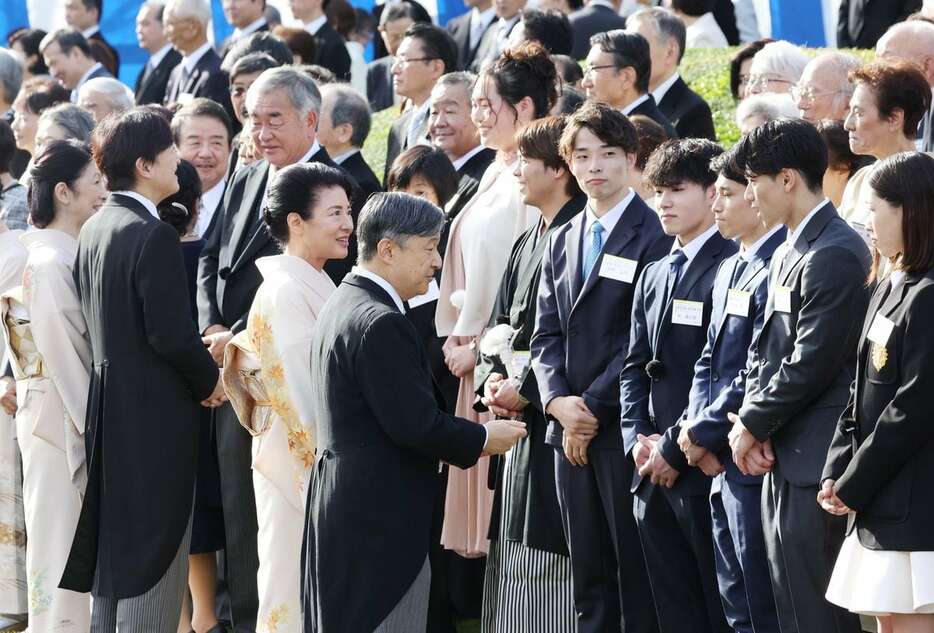 秋の園遊会で、パリ五輪男子体操団体で金メダルを獲得した橋本大輝選手（手前右から2人目）らと懇談される天皇、皇后両陛下＝30日午後、東京・元赤坂の赤坂御苑（安元雄太撮影）