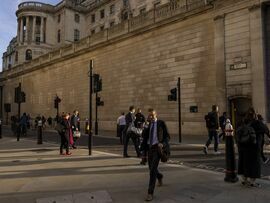 Commuters cross a junction outside the Bank of England in the City of London. Photographer: Jason Alden/Bloomberg