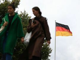 The German national flag near the Brandenburg Gate in Berlin. Photographer: Krisztian Bocsi/Bloomberg