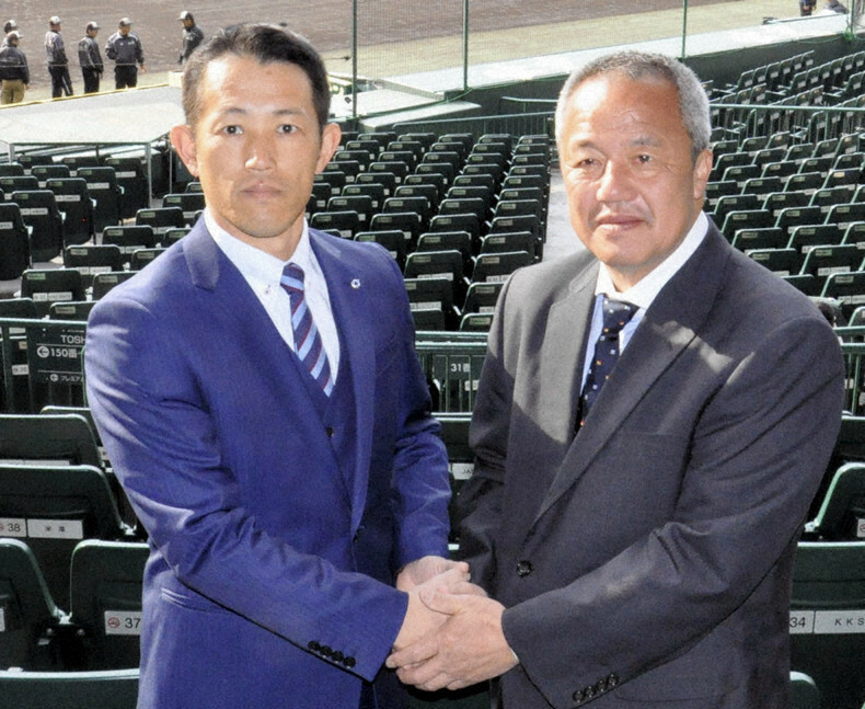 健闘を誓い合う履正社の岡田龍生監督（右）と星稜の林和成監督＝兵庫県西宮市の阪神甲子園球場で