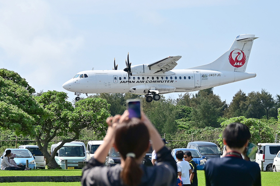 喜界空港に隣接する公園では、離着陸する航空機を間近で楽しめる＝4月、鹿児島県喜界町の空港臨海公園