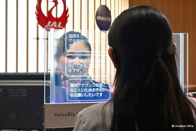 羽田空港で実施されたVoiceBiz UCDisplayの実証実験で聴覚障がいを持つ利用者役の社員（手前）と字幕でやり取りするJALのグランドスタッフ＝24年7月2日 PHOTO: Tadayuki YOSHIKAWA/Aviation Wire