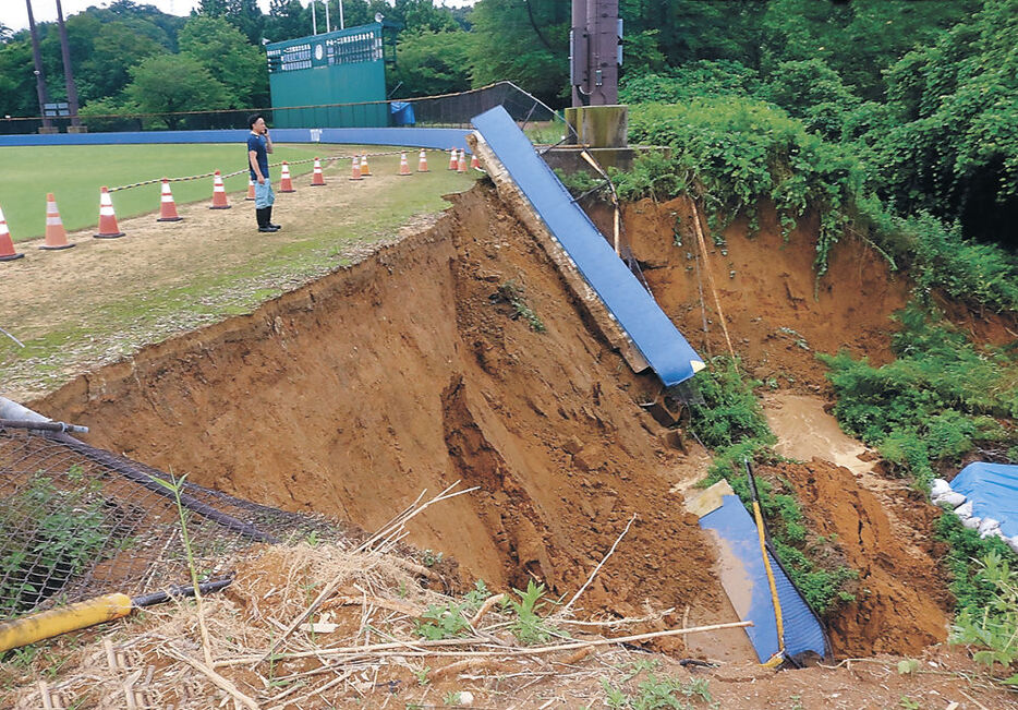 外野フェンスごと崩落したのり面＝２０日午前９時４５分、かほく市高松野球場