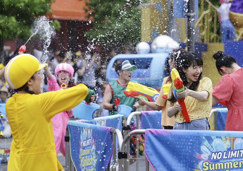 報道関係者に公開されたUSJの夏のイベントで、水をかけ合う招待客ら＝2日午前、大阪市