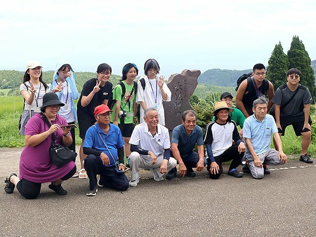 氷見市長坂の棚田で記念写真に納まる学生たち