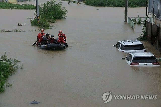 京畿道坡州市で救助活動を行う消防隊員＝18日、ソウル（聯合ニュース）