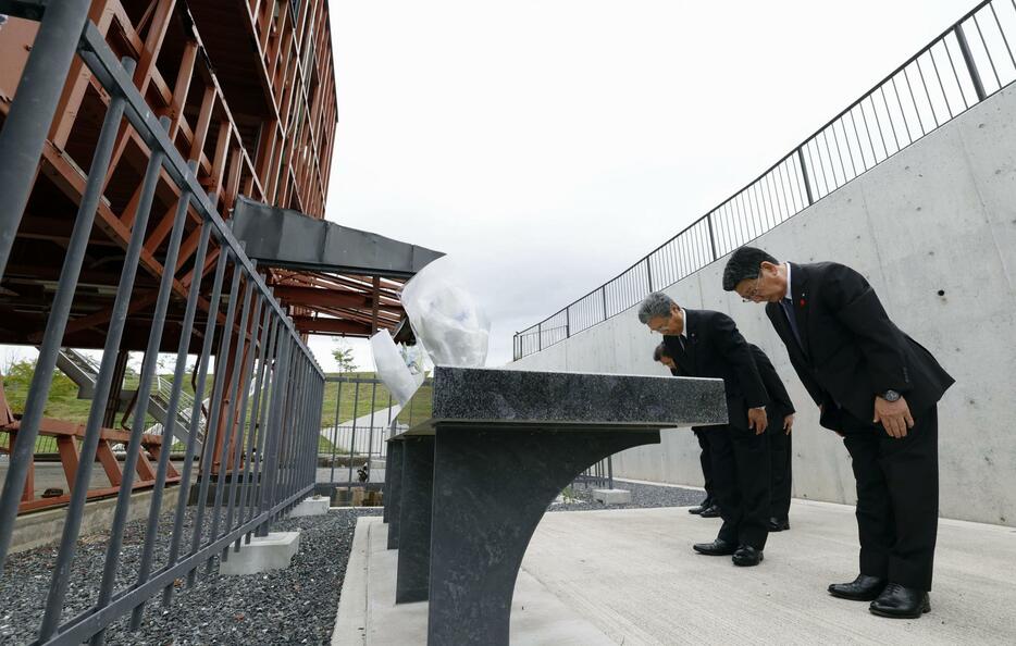 宮城県南三陸町の旧防災対策庁舎に献花し、黙とうする佐藤仁町長（右）ら＝1日午前