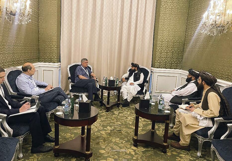 タリバン側代表団を率いたムジャヒド報道官（中央右）＝6月30日、ドーハ（AP＝共同）