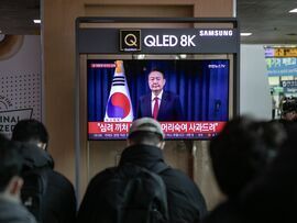 <p>A television screen shows a live broadcast of South Korean President Yoon Suk Yeol delivering a speech</p>