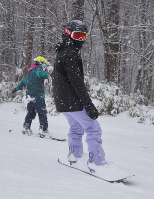 雫石スキー場で新雪の感触を楽しむスノーボーダー