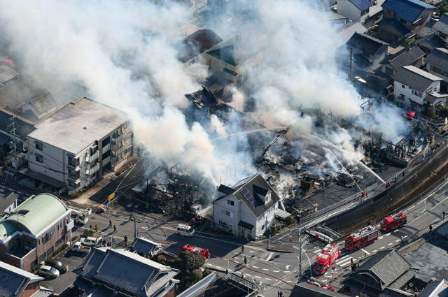 煙を上げて燃える建物=2024年12月28日午後0時47分、奈良県三郷町、朝日放送テレビヘリから、水野義則撮影