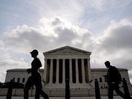 Pedestrians walk past the US Supreme Court in Washington, DC. Photographer: Stefani Reynolds/Bloomberg