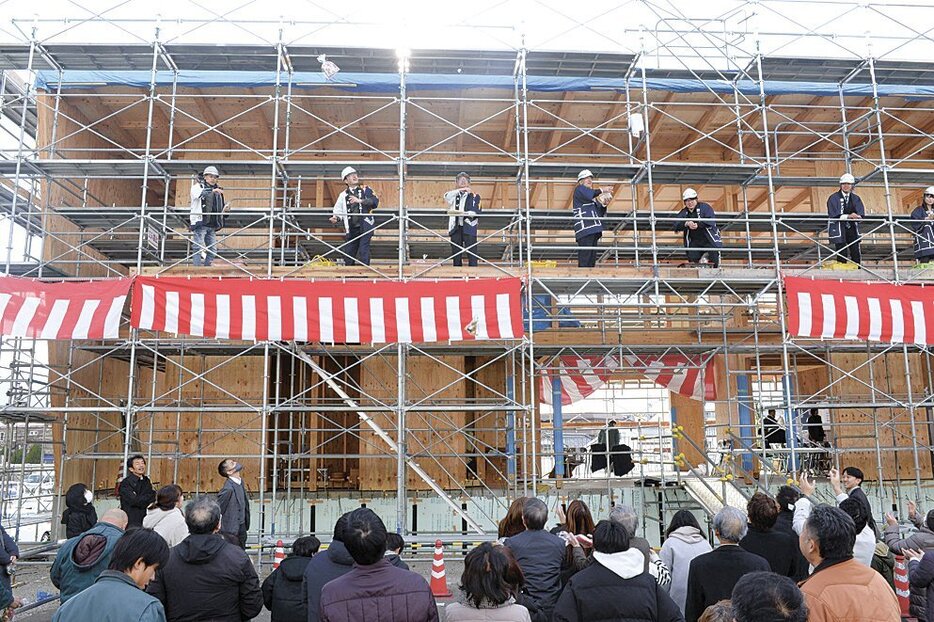 骨組みが出来上がった新社屋で行われた餅まき