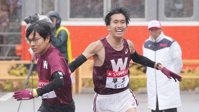 雨の中で力走をみせる石塚陽士選手(右)とタスキを受け取る工藤慎作選手(左)〈写真：日刊スポーツ/アフロ〉