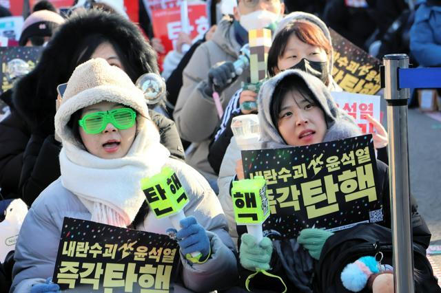 ソウルの韓国国会の前で、ペンライトを手に尹錫悦（ユンソンニョル）大統領の弾劾（だんがい）訴追案の可決を求める市民ら=2024年12月14日、太田成美撮影