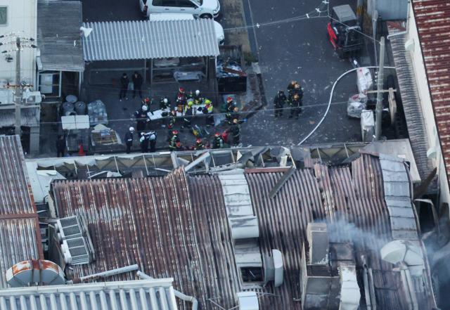 火災のあった建物の近くでは消火活動が続いていた=2024年12月28日午後4時41分、大阪府門真市、朝日放送テレビヘリから、水野義則撮影