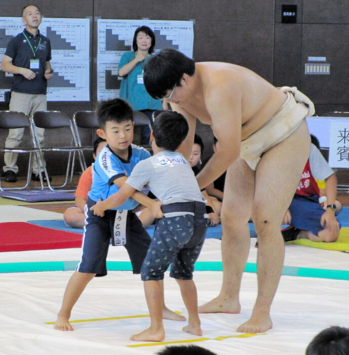 学生力士が取組を教えた２０１９年の子ども相撲（沖野市民センター提供）