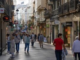 Visitors pass shops in the old town in A Coruna, Spain. Photographer: Manaure Quintero/Bloomberg