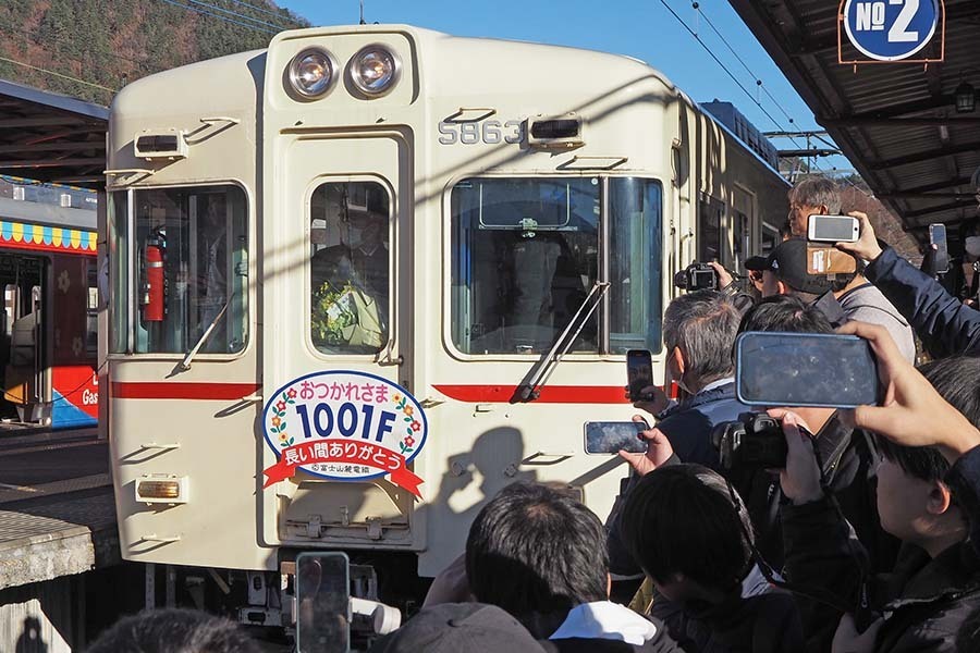 もと京王5000系の1000形1001号編成を撮影する愛好家ら。2024年12月15日、河口湖駅（大塚圭一郎撮影）。