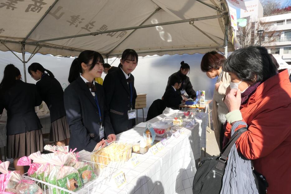 店先で接客する生徒たち=岡山県津山市、城下スクエアで