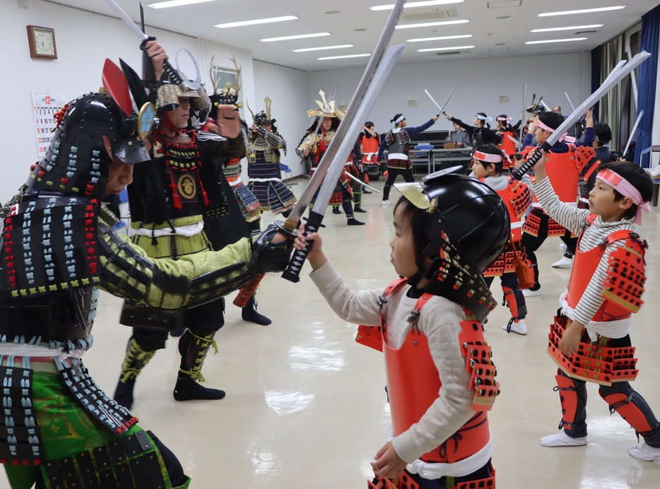 新作能「直正」の合戦シーンの練習に励む子どもや「大丹波手づくり甲冑隊」のメンバーたち＝兵庫県丹波市春日町黒井で