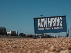 A "Now Hiring" sign along the highway in Midland, Texas, US. Photographer: Jordan Vonderhaar/Bloomberg