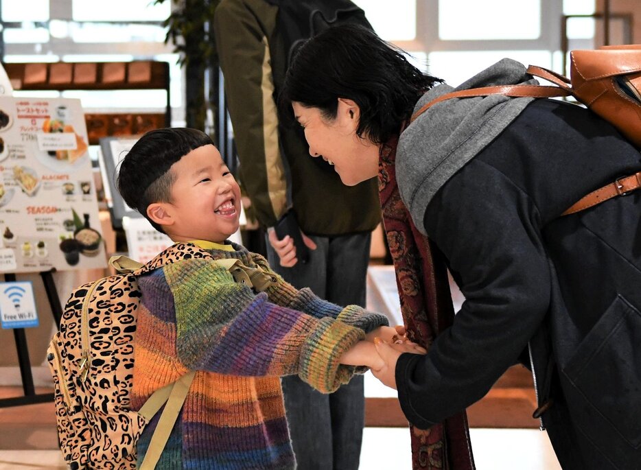 鳥取の親族との再開を喜ぶ子ども（左）＝２８日、鳥取市湖山町西４丁目の鳥取砂丘コナン空港