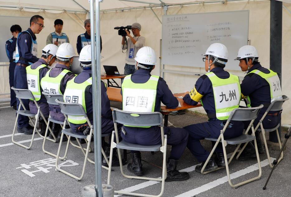 他電力からの応援受け入れを想定した訓練をする沖縄電力の職員ら＝６日、北中城村のイオンモール沖縄ライカム