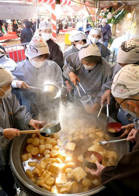 大鍋で炊きあげた熱々の大根や揚げを盛りつける人たち=2024年12月7日午前、京都市上京区、新井義顕撮影